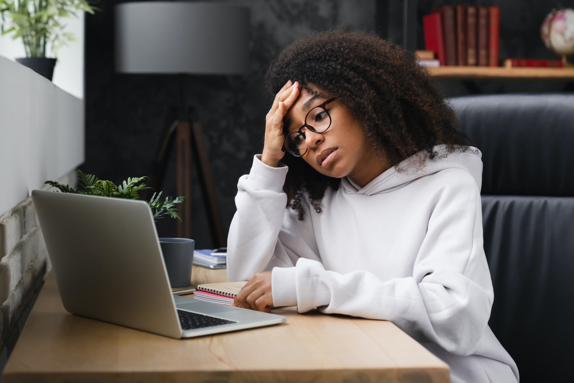 Student using laptop, having headache after hard-working day of e-learning, failed exam test